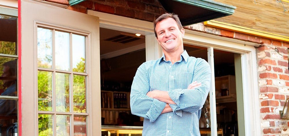 Person standing in front of a small business