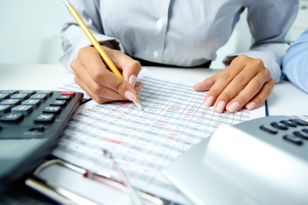 Person working on a balance sheet.