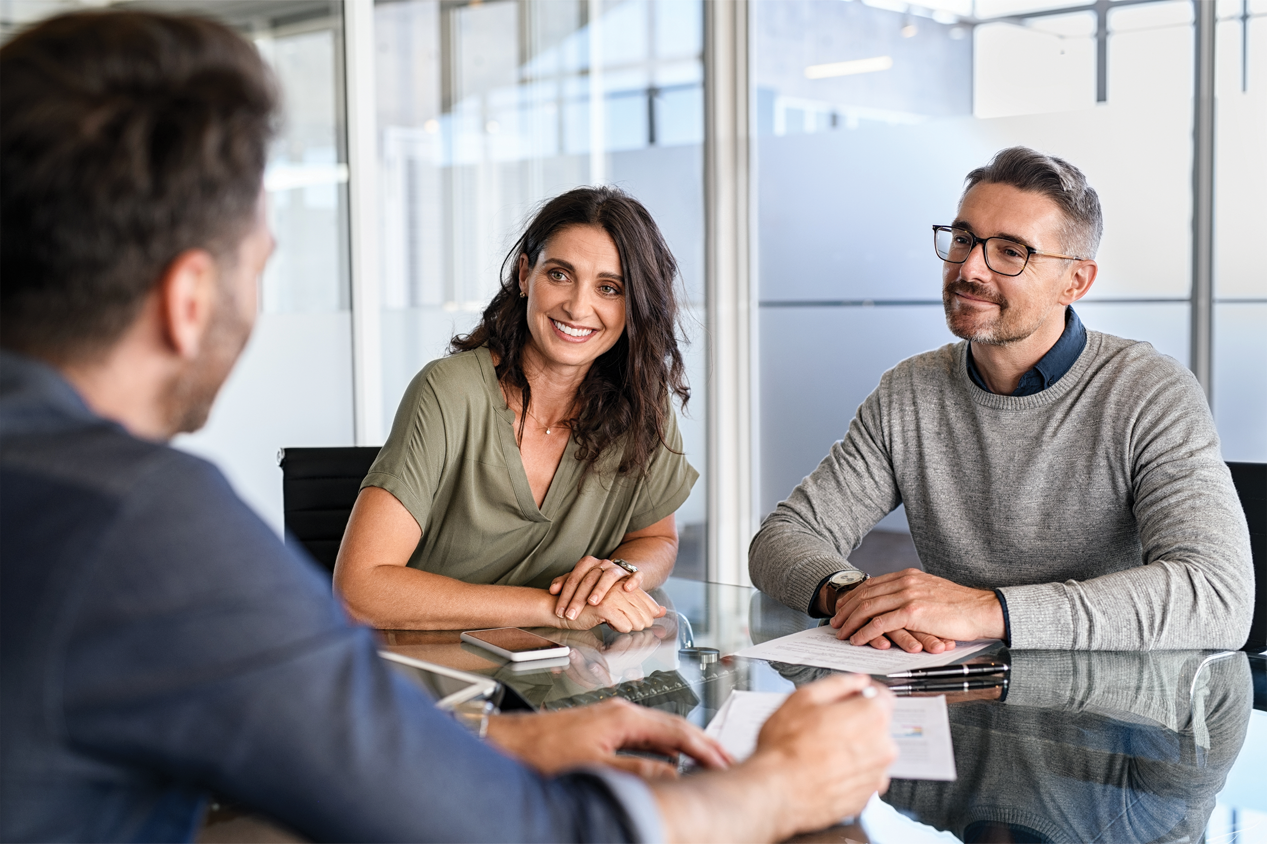Two happy people working with a banker.
