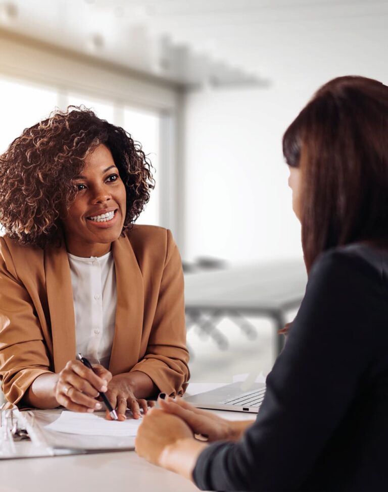 A loan specialist reviewing documents with a customer