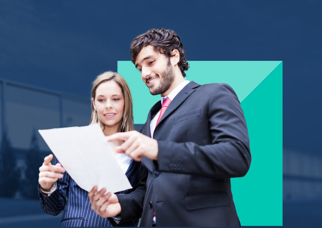 Two real estate professionals reviewing papers