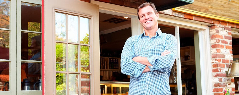 Scale Bank is an SBA Preferred Lender.|Person standing in front of a small business|Scale Bank is an SBA Preferred Lender.