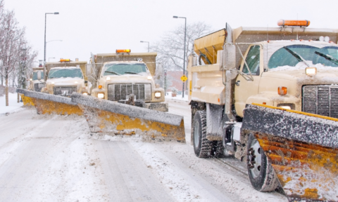 Snowplows clearing a snowy road