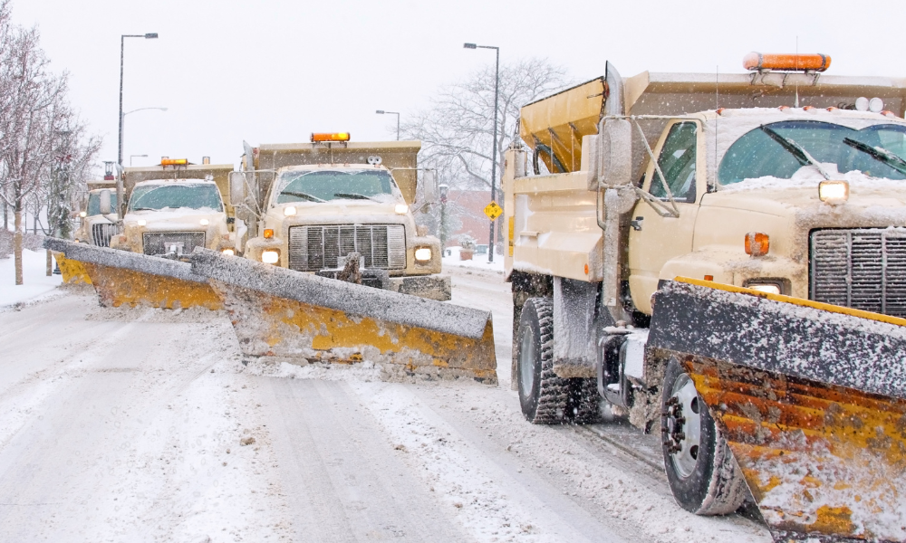 Snowplows clearing a snowy road