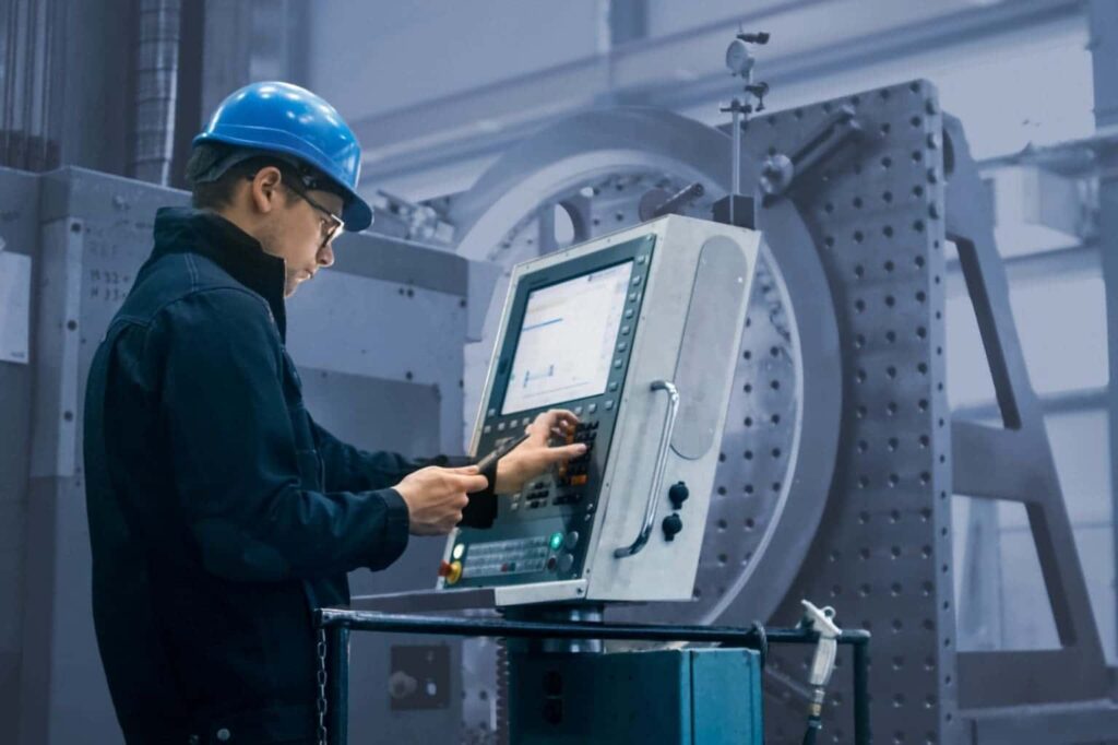 An industrial equipment operator using a machine's interface