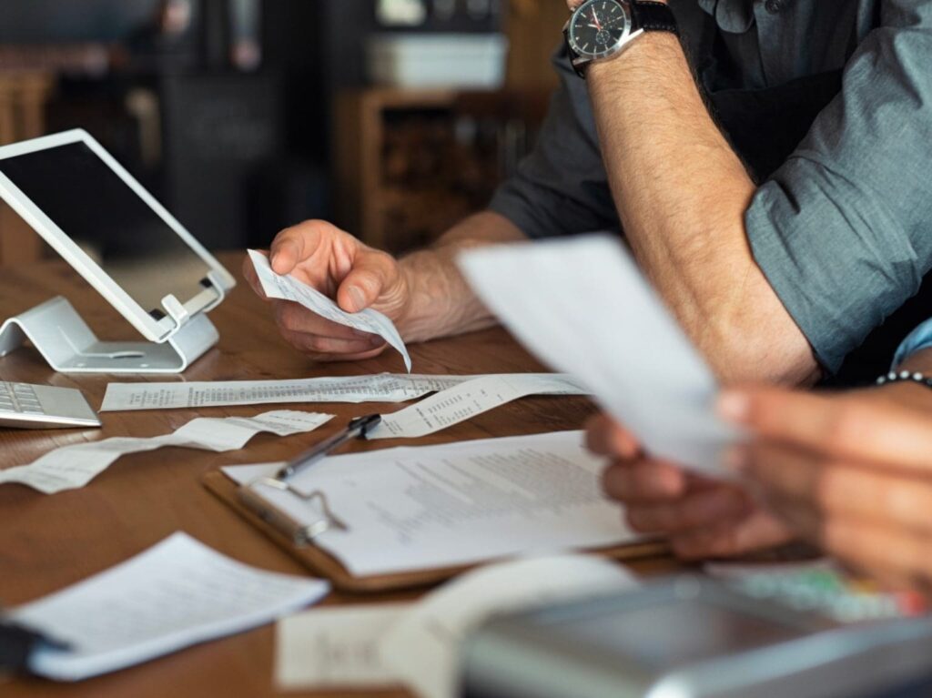 Business person looking through receipts