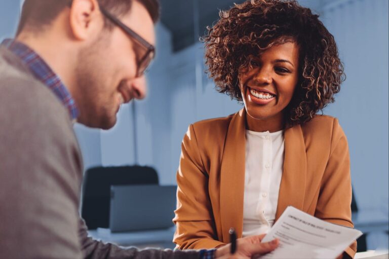 A smiling loan specialist working with a customer
