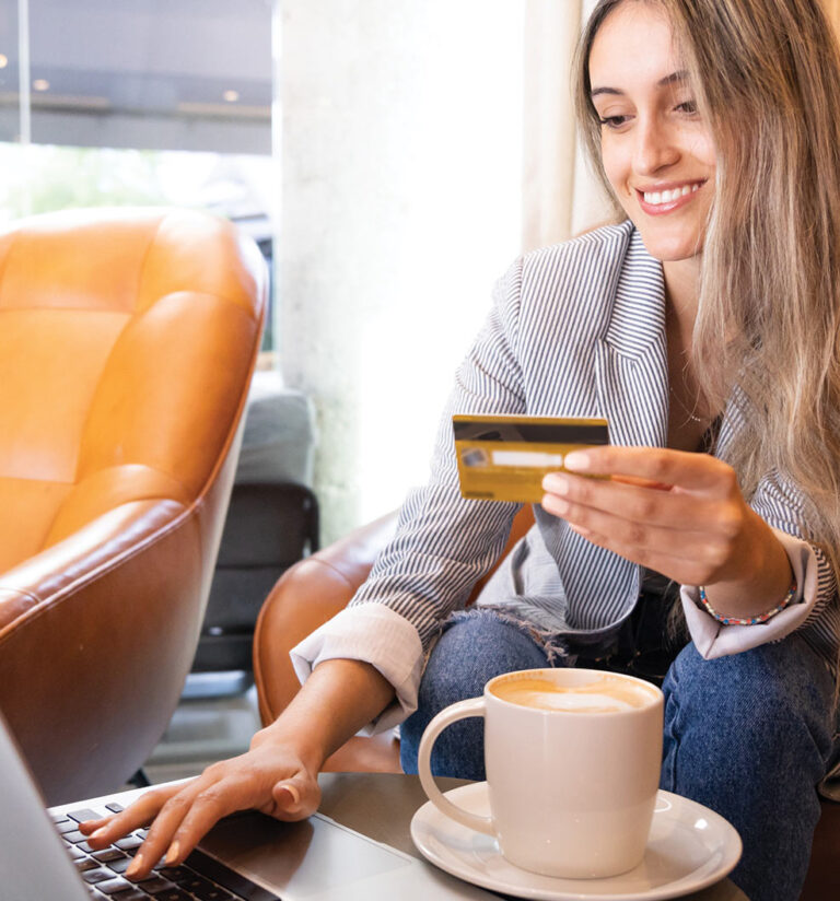 Woman entering credit card information into a mobile phone
