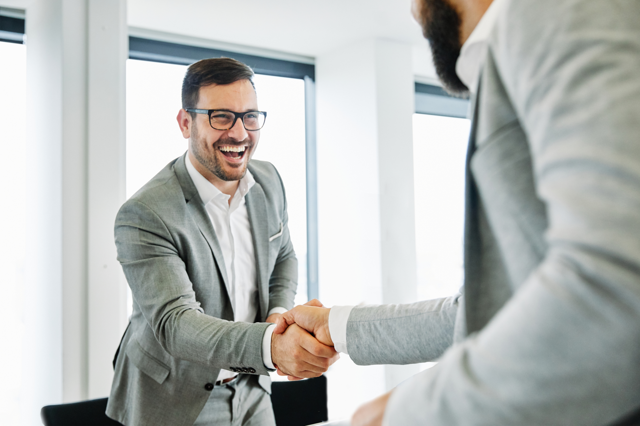 Two happy business men shaking hands.